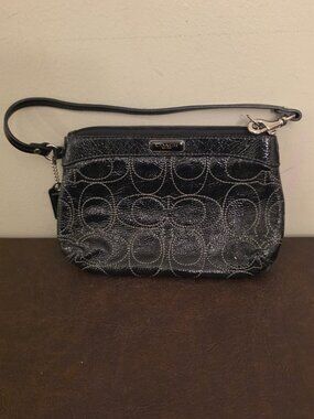 The Coach Signature Stitched Patent Leather Wristlet in black silver